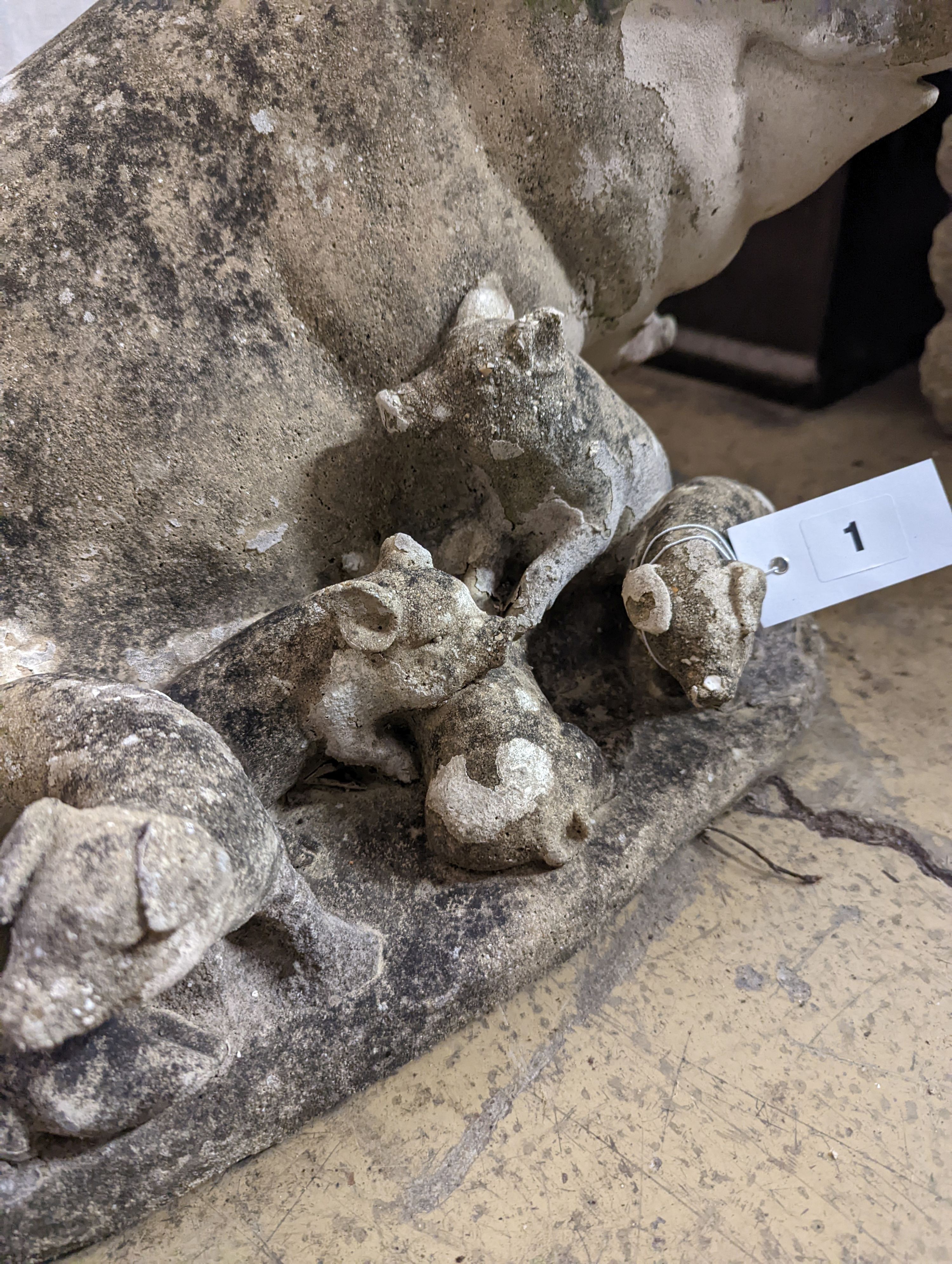 A reconstituted stone garden ornament of a sow with piglets, width 56cm, height 35cm